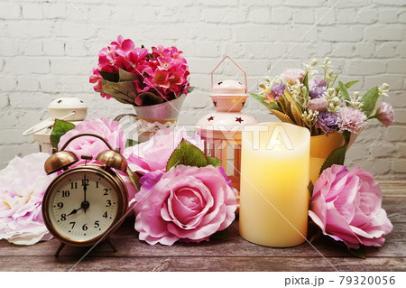 Candles and alarm clock interior decoration on white brick wall background Candles and alarm clock interior decoration on white brick wall background 79320056
