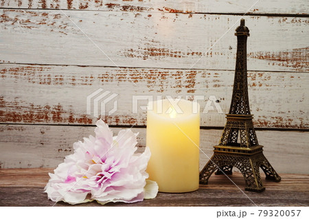 Souvenir Eiffel and Flameless Candles with flower decoration on wooden background Souvenir Eiffel and Flameless Candles with flower decoration on wooden background 79320057