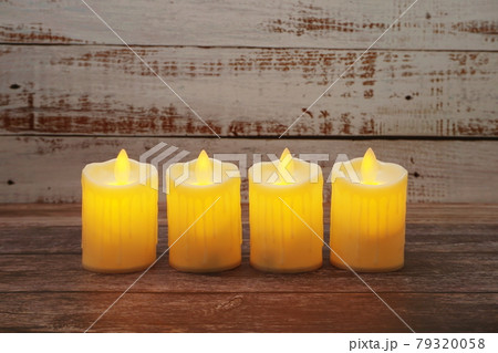 Flameless candles electronic on wooden background Flameless candles electronic on wooden background 79320058