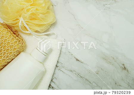 Shower accessories bath items shower bottle, sponge and fibre scrub on marble background 79320239
