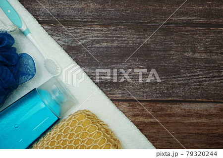 Shower accessories bath items shower gel, sponge and fibre scrub on wooden background 79320244