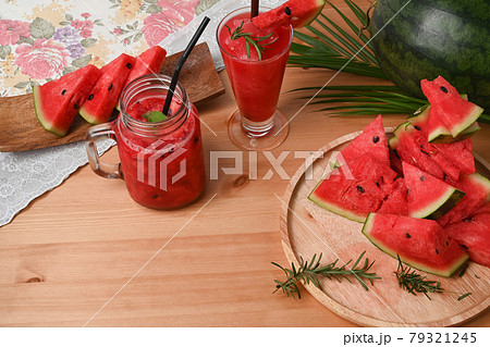 Watermelon smoothie in Mason jar on wood table. Watermelon smoothie in Mason jar on wood table. 79321245