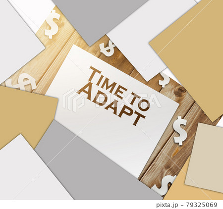 text Time to Adapt page, paper signs of dollar on wood table. Business concept 79325069