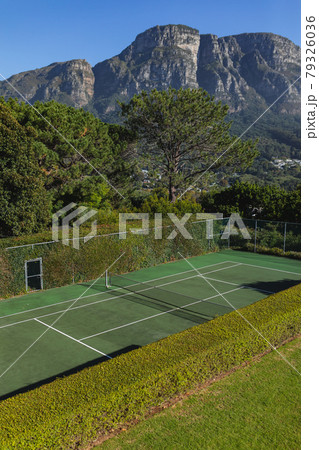 General view of tennis court in stunning countryside on sunny day 79326036