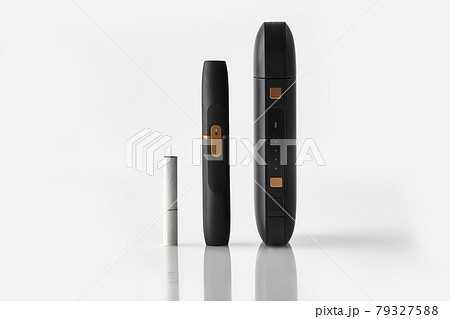 New generation black electronic cigarette, battery and one heatstick isolated on white. Hi-tech heating tobacco system. Advertising, close up New generation black electronic cigarette, battery and one heatstick isolated on white. Hi-tech heating tobacco system. Advertising, close up 79327588