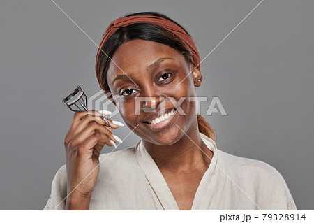 Beautiful African American Woman Curling Eyelashes Beautiful African American Woman Curling Eyelashes 79328914