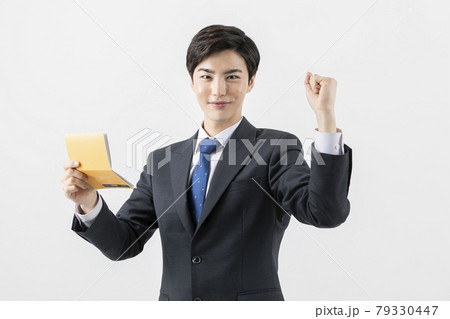 happy Asian man checking his balance in bank book 79330447