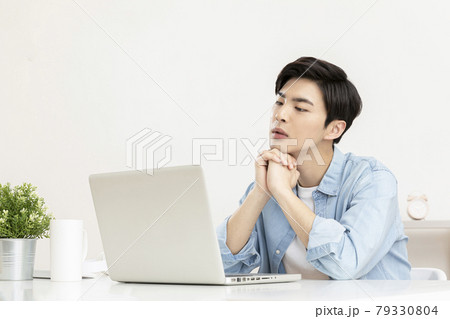 young Asian handsome man distressed, in worry, using laptop young Asian handsome man distressed, in worry, using laptop 79330804