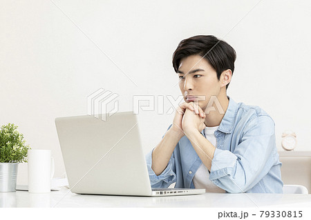 young Asian handsome man distressed, in worry, using laptop 79330815