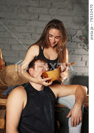 young caucasian couple together having fun on kitchen, woman pregnant, drinking milk, lifestyle people concept 79333470