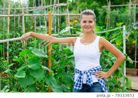 Portrait of cheerful woman in garden on sunny day 79333653