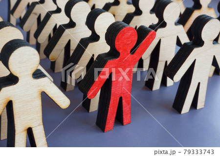 Initiative and activism concept. Unique figurine with a raised hand in a crowd. 79333743