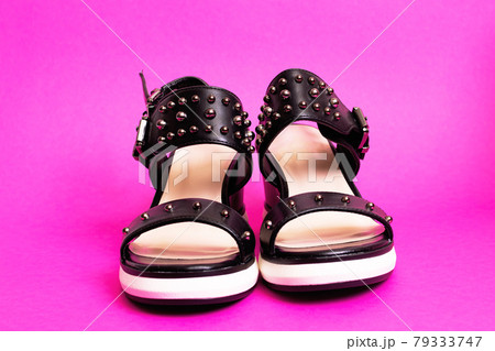 Women's sandals on a pink background closeup 79333747