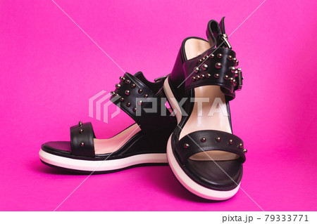 Women's sandals on a pink background closeup 79333771