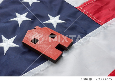 VA Streamline Refinance for home loan concept. A small house lies on the American flag. VA Streamline Refinance for home loan concept. A small house lies on the American flag. 79333775