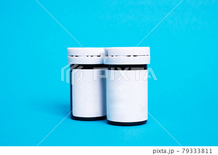 Two jars of medicines on a blue background 79333811