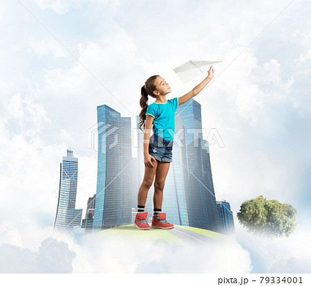 Concept of careless happy childhood with girl dreaming about future Concept of careless happy childhood with girl dreaming about future 79334001