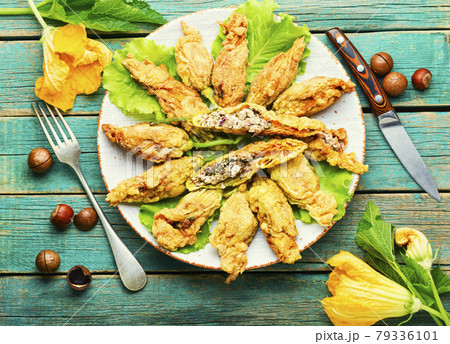 Stuffed zucchini or courgette flowers,flat lay Stuffed zucchini or courgette flowers,flat lay 79336101