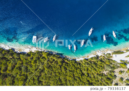 Top down aerial view of sailing boats docked in blue bay of Fiskardo, Kefalonia island, Ionian, Greece Top down aerial view of sailing boats docked in blue bay of Fiskardo, Kefalonia island, Ionian, Greece 79336137