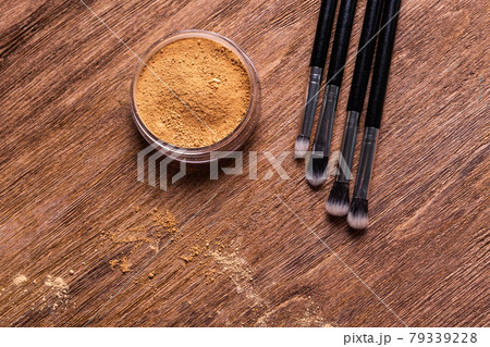 Mineral powder foundation with brushes on a wooden background. Eco-friendly and organic beauty products Mineral powder foundation with brushes on a wooden background. Eco-friendly and organic beauty products 79339228