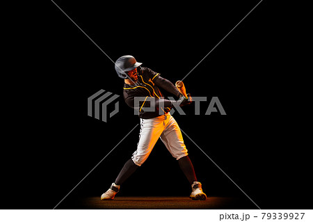 Professional baseball player, pitcher in sports uniform and equipment playing baseball isolated on black studio background in neon light. Team sport concept 79339927