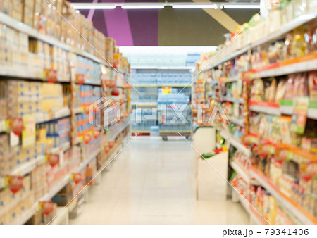 Bokeh blurry background of aisle of label products on shelves at supermarket or grocery store. Food shopping. Lifestyle. Abstract 79341406