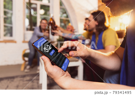 Bet for winner. Group of friends watching TV, sport match together. Concept of friendship, leisure activity, emotions Bet for winner. Group of friends watching TV, sport match together. Concept of friendship, leisure activity, emotions 79341495