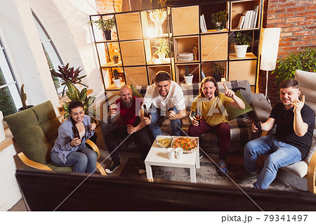 Bet for winner. Young men watching TV, sport match together. Concept of friendship, leisure activity, emotions 79341497