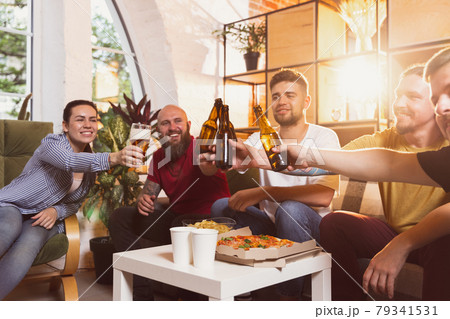 High angle view of group of young people spending time together. Concept of friendship, leisure activity, emotions High angle view of group of young people spending time together. Concept of friendship, leisure activity, emotions 79341531
