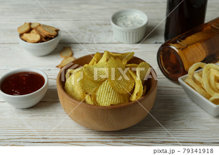Different snacks, beer and sauces on white wooden background Different snacks, beer and sauces on white wooden background 79341918