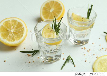 Shots of tequila on white background, close up Shots of tequila on white background, close up 79341968