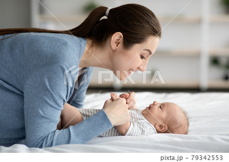 Mother-Child Connection. Happy Loving Young Mommy Bonding With Newborn Child At Home Mother-Child Connection. Happy Loving Young Mommy Bonding With Newborn Child At Home 79342553