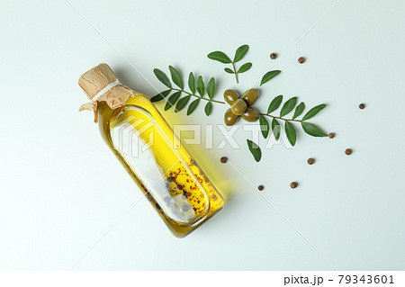 Bottle of oil, olives, twigs and pepper on white background Bottle of oil, olives, twigs and pepper on white background 79343601