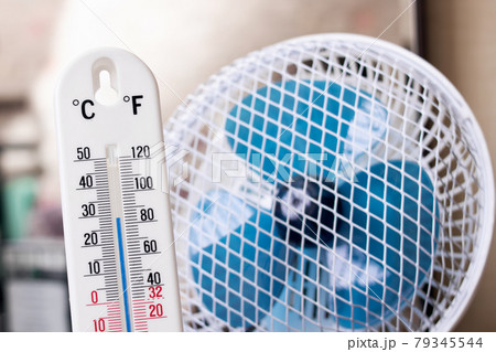 Small fan and room mercury thermometer closeup Small fan and room mercury thermometer closeup 79345544