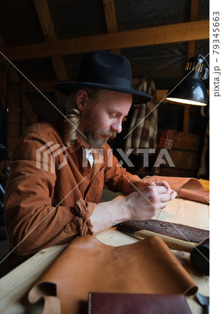 Worker working with leather textile in workshop Worker working with leather textile in workshop 79345663