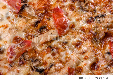 Fresh delicious Italian pizza with mushrooms and tomatoes on a dark concrete background 79347181