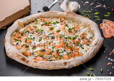 Tasty sliced pizza with seafood and tomato on black background 79347229
