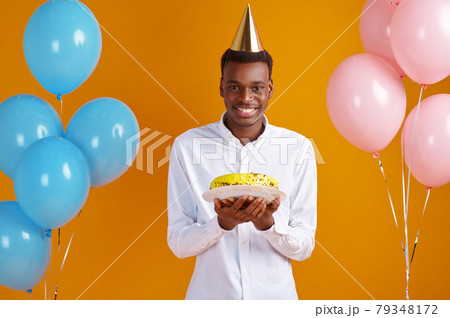 Man in cap with birthday cake Man in cap with birthday cake 79348172