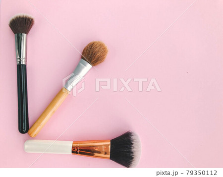 paintbrushes on a pink background. glamorous makeup artist table. brushes for applying powder, blush, foundation. natural bristle makeup brushes paintbrushes on a pink background. glamorous makeup artist table. brushes for applying powder, blush, foundation. natural bristle makeup brushes 79350112