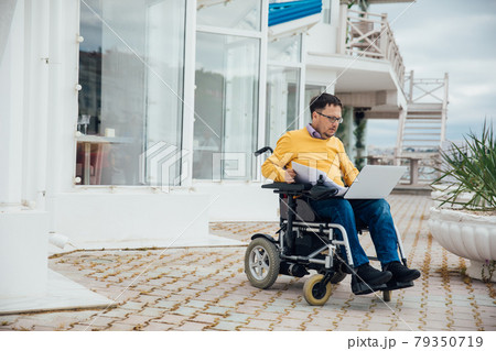 man with disabilities in wheelchair job business online 79350719