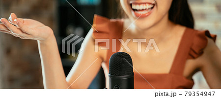 Woman with mic recording a podcast Woman with mic recording a podcast 79354947