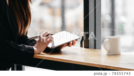 Close up business woman working with digital tablet on wooden desk with coffee morning 79355743