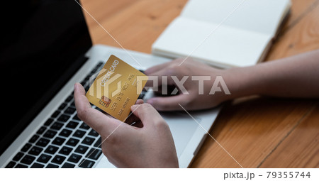 Hand holding credit card and using laptop. Online shopping, e-commerce, internet banking, spending money 79355744
