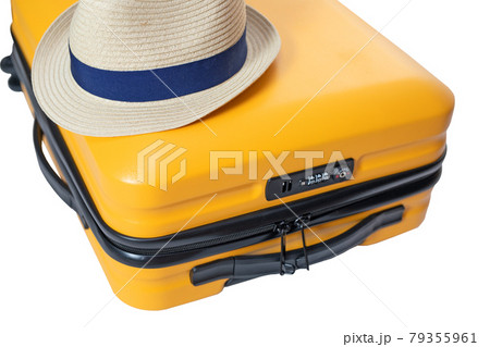 yellow suitcase with a combination lock with numbers 666 on it. Summertime - travel bag and straw hat on top yellow suitcase with a combination lock with numbers 666 on it. Summertime - travel bag and straw hat on top 79355961