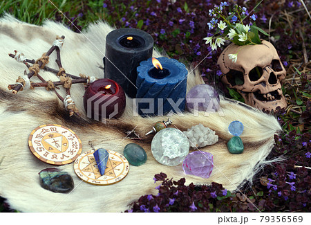 Beltane still life with ritual objects, skull, burning candles, pentagram and crystals outside. Esoteric, gothic and occult background, Halloween mystic and wicca concept. Beltane still life with ritual objects, skull, burning candles, pentagram and crystals outside. Esoteric, gothic and occult background, Halloween mystic and wicca concept. 79356569