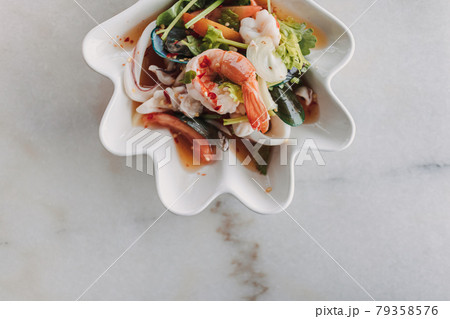 Thai seafood spicy salad served in a fancy bowl. Thai seafood spicy salad served in a fancy bowl. 79358576
