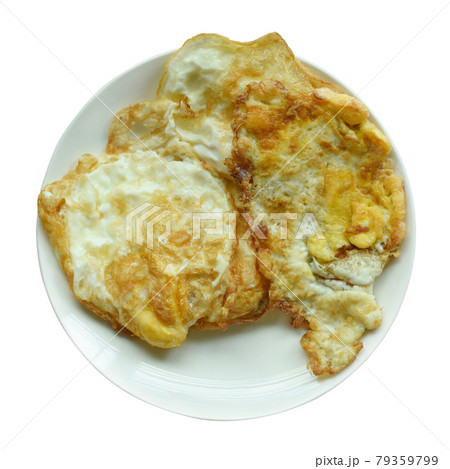 Fried eggs in a white plate on white background Fried eggs in a white plate on white background 79359799