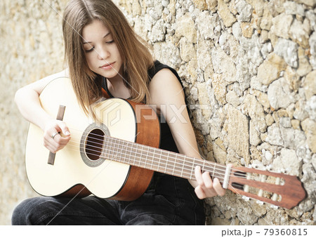 Teenage girl with a guitar Teenage girl with a guitar 79360815