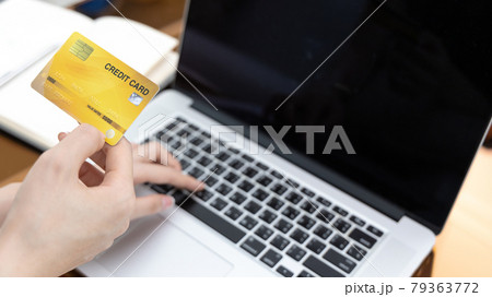 Asian woman lounging on sofa and using laptop to shop online with credit card to register for payment or online transactions, Financial transactions and Internet security, Shopping with credit card. 79363772