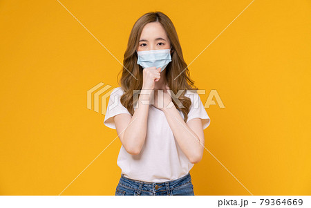 Asian woman wear masks to protect disease on yellow background. 79364669